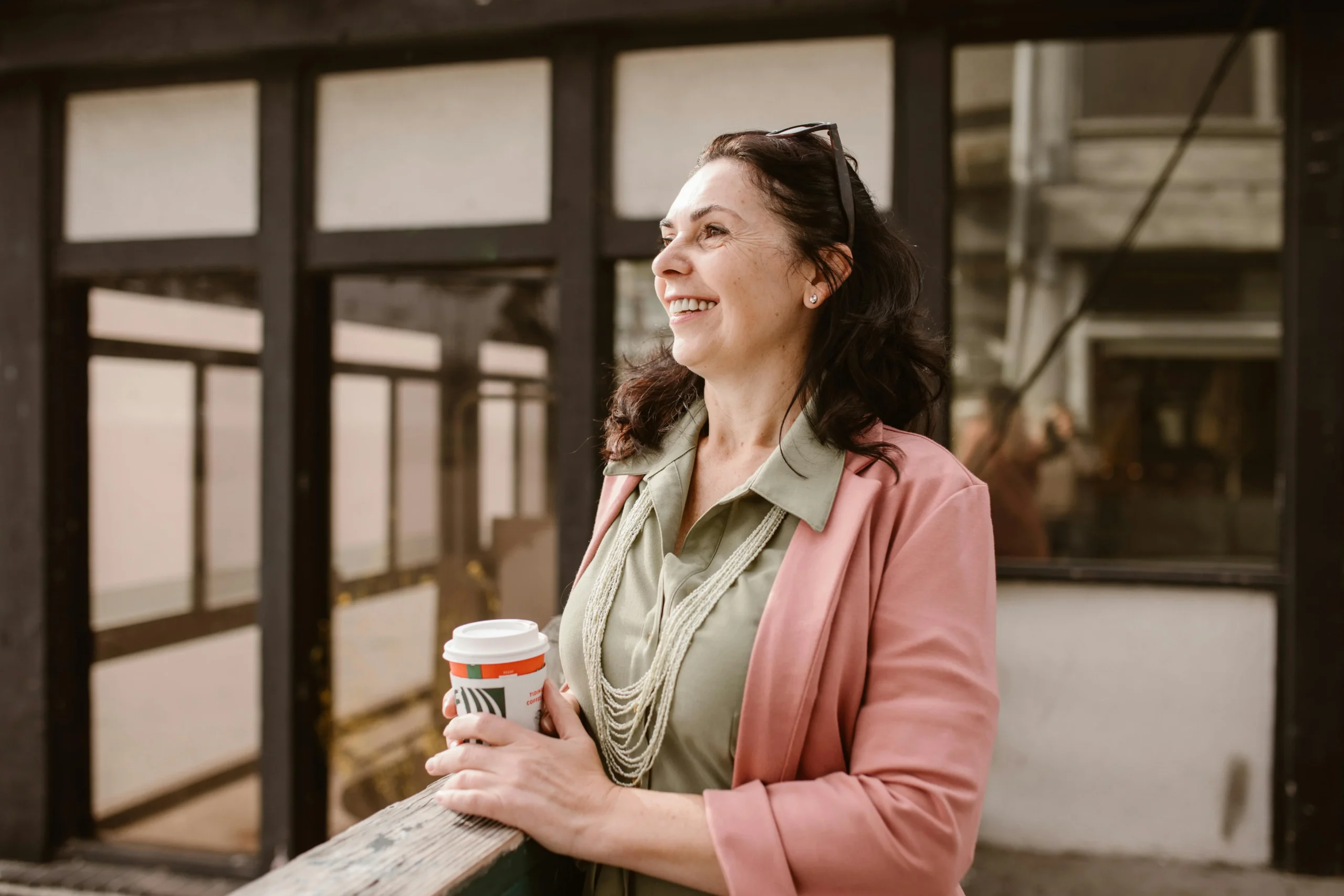 Elegant woman over 50 wearing a classic trench coat and stylish accessories, showcasing timeless fashion trends for women over 50.